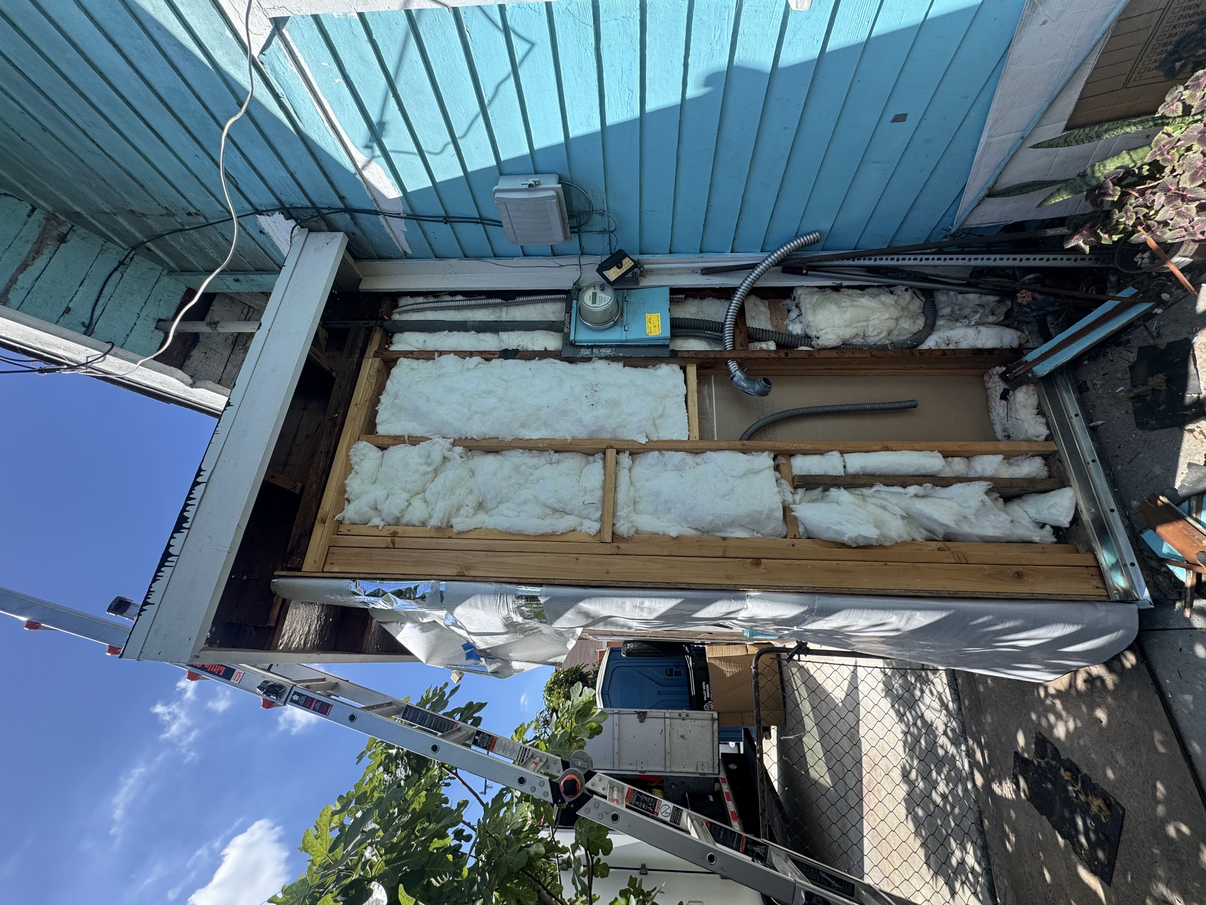 Before: 100A panel — wall opened, rusted cabinet, unsafe connections